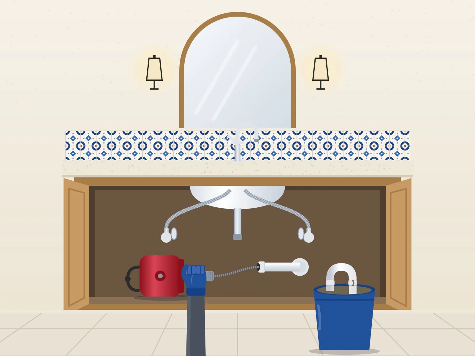 Illustration of an open vanity cabinet, a gloved hand guiding a red drain auger cable into the drain pipe, the trap in a blue bucket